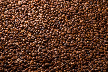 many coffee beans lie on the table background
