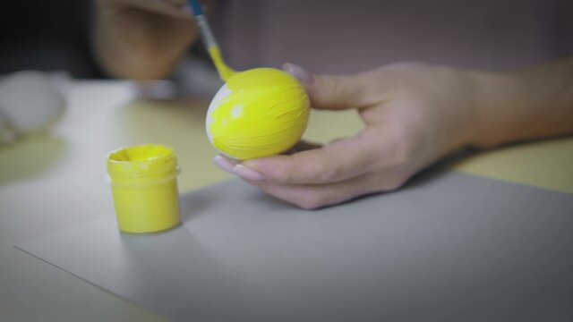 Yellow colored easter egg on a gray background. Panton 2021. Spring Easter concept