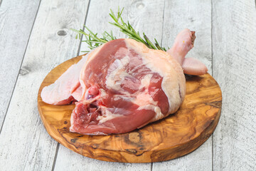 Raw duck leg served rosemary
