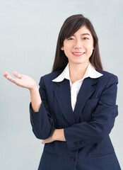 Asian woman in suit open hand palm gestures with empty space