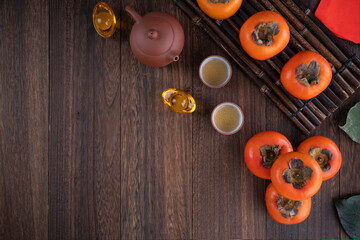 Top view of fresh persimmons on wooden table background for Chinese lunar new year
