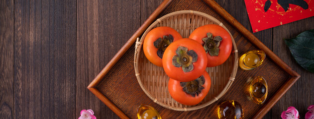 Top view of fresh persimmons on wooden table background for Chinese lunar new year