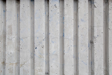 fragment of a concrete wall with vertical stripes