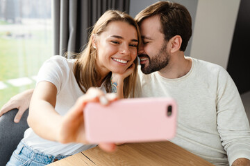 Happy cheerful couple taking a selfie