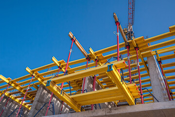 Horizontal formwork and crane at the construction of a residential building.