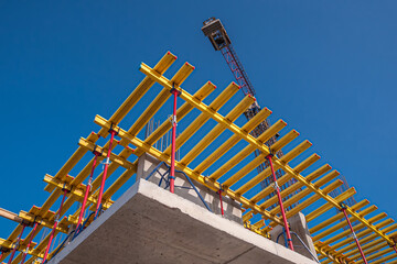 Horizontal formwork and crane at the construction of a residential building.