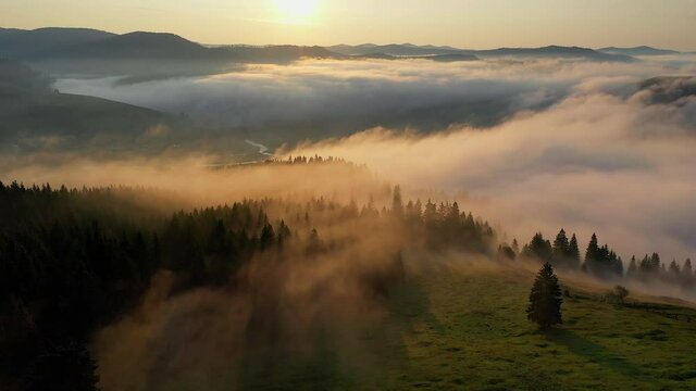 4K Aerial view of an amazing summer sunrise over villages with old houses from Bucovina Romania