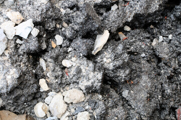 broken concrete floor at building construction site. cracked concrete texture background. Grey...