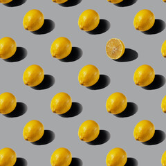 A pattern of whole lemons on a gray background. Healthy food concept. Flat lay.