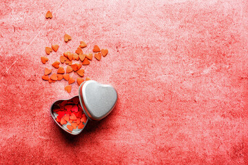 Valentine's day composition - candy hearts on red stone background. Love romantic concept. Flat lay, top view, copy space.