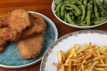 breaded meat with fried potatoes and edamame as kids food