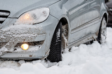 car tires on winter road covered with snow, close-up