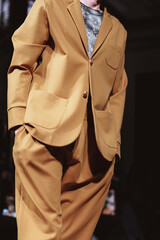 Cropped figure of a man wearing a stylish beige suit