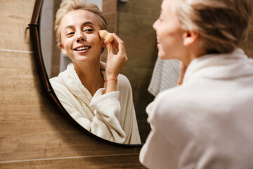 Attractive young woman wearing bathrobe