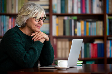 A elderly woman use the laptop for Internet conversation. The modern lifestyle of seniors.