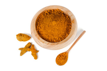 Turmeric powder spice heap and dry turmeric roots in a wooden bowl with wooden spoon isolated on a white background. Top view.