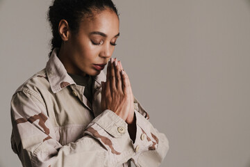 African american soldier woman holding palms together while praying