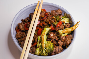 ceramic casserole of ground beef stir-fry with vegetables broccoli pepper and onion on a white base Cordoba Argentina