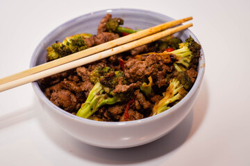 ceramic casserole of ground beef stir-fry with vegetables broccoli pepper and onion on a white base Cordoba Argentina