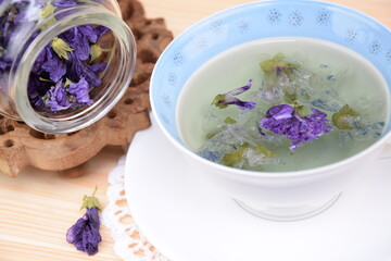 Mallow tea, herbal tea with dried mallow flowers in cup
