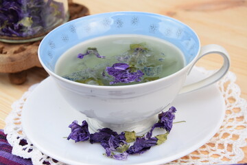 Mallow tea, herbal tea with dried mallow flowers in cup