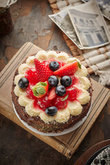 Black forest cake, Schwarzwald pie, dark chocolate and cherry dessert on a white wooden background.