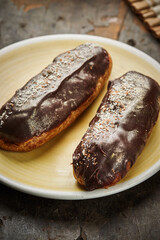 Traditional french eclairs with chocolate. Tasty dessert. Home made cake eclairs. Sweet. Dessert. Pastry filled with cream. Chocolate icing.