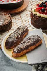 Traditional french eclairs with chocolate. Tasty dessert. Home made cake eclairs. Sweet. Dessert. Pastry filled with cream. Chocolate icing.