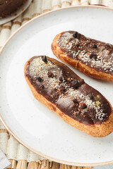 Traditional french eclairs with chocolate. Tasty dessert. Home made cake eclairs. Sweet. Dessert. Pastry filled with cream. Chocolate icing.