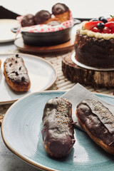 Traditional french eclairs with chocolate. Tasty dessert. Home made cake eclairs. Sweet. Dessert. Pastry filled with cream. Chocolate icing.