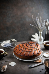 Seashell cake with chocolate icing on a gray table. Unusual sweets.