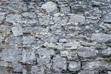 Background and texture of an old stone wall close up