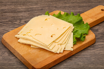 Sliced yellow cheese over board