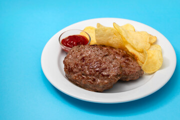 fried ground meat with tomato sauce and potato chips on dish