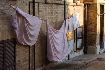 Sheets spread out on the street in an Italian village (Pesaro, Italy, Europe)