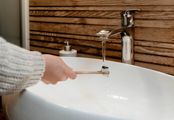 Closeup shot of a person washing their hand © Marko Klarić/Wirestock