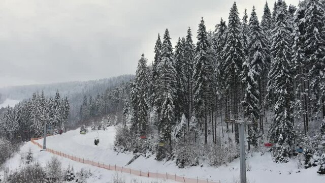skiing and snowboarding at a ski resort in the included spotlights and running ski lifts. Ski resort Slavske, Ukraine. Timelapse