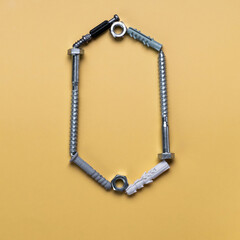 Alphabet letter O made of bolts, screws, typeset