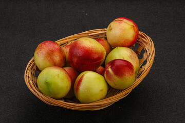 Sweet small nectarines in the basket