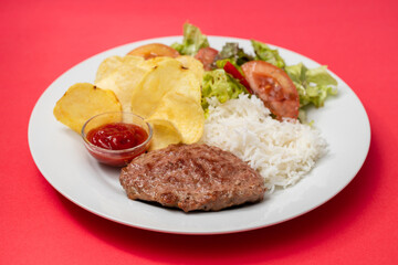 Naklejka na ściany i meble fried ground meat with tomato sauce and boiled rice on dish