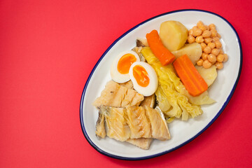 boiled cod fish with boiled vegetables and egg on white dish