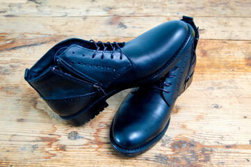 Stylish men black shoes on old wood background image