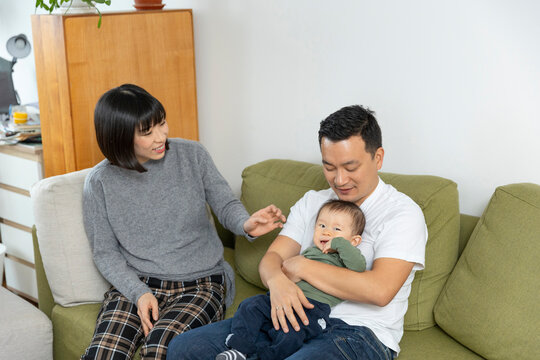 Portrait of a happy asain family in living room