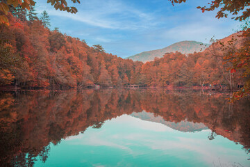 autumn in the mountains, blue sky and reflections on the lake.