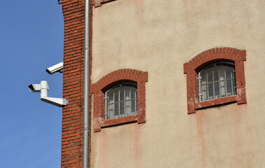 Fototapeta na wymiar CCTV cameras and prison windows