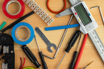 Electrical installation tools scattered on the wooden surface
