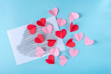 DIY and kid's creativity. Step by step instruction: how to make valentine card, hedgehog with hearts. Step3 Cutting out pink and red hearts from paper. Craft for Valentines day.