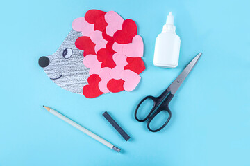 DIY and kid's creativity. Step by step instruction: how to make valentine card, hedgehog with hearts. Step8 Finished postcard gift. Craft for Valentines day.