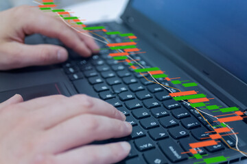 financial business analytics concept, candlestick chart, check market data and growth financial stock market graph on over blurred keyboard background