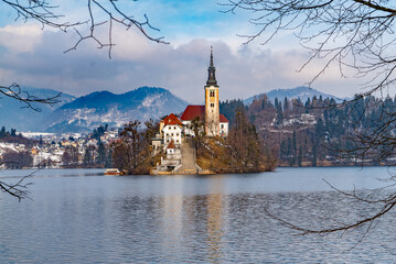 Lake Bled in Slovenia. A Island with a church and mountains with snow.